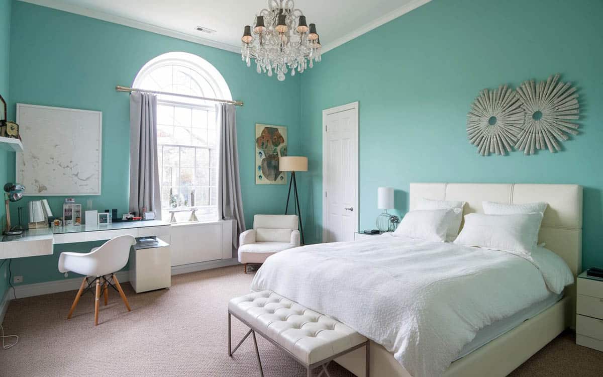 Teal painted room with high ceiling and chandelier