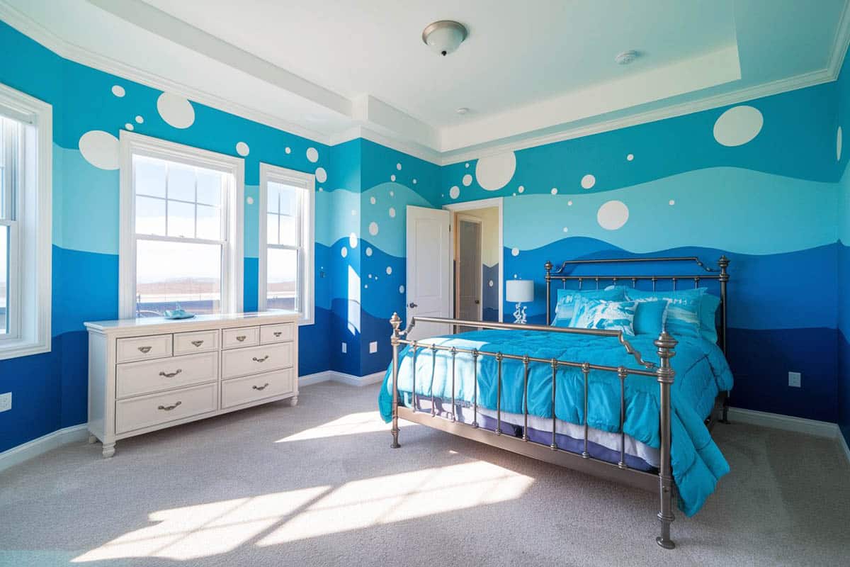 Tropical bedroom with blue painted walls with wave art design