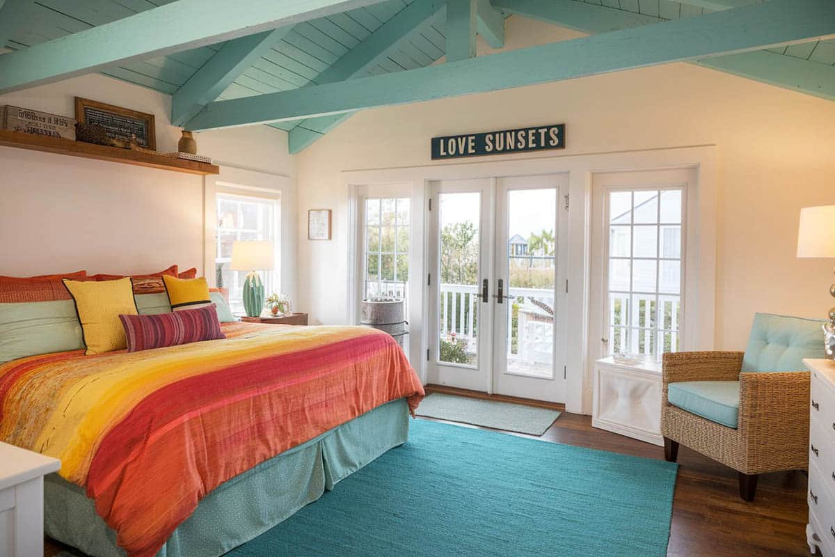 Tropical beach bedroom with teal rug, teal color ceiling and colorful bedding