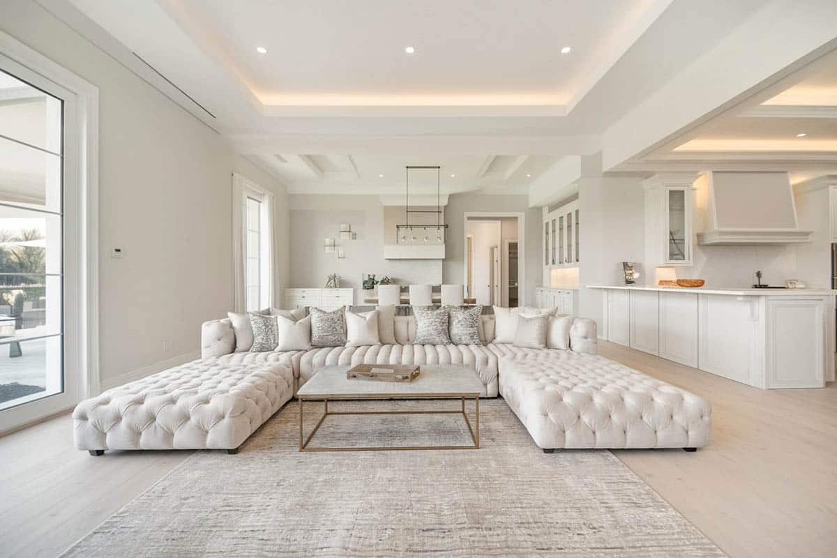 Contemporary living room with porcelain tile floors and white tufted furniture