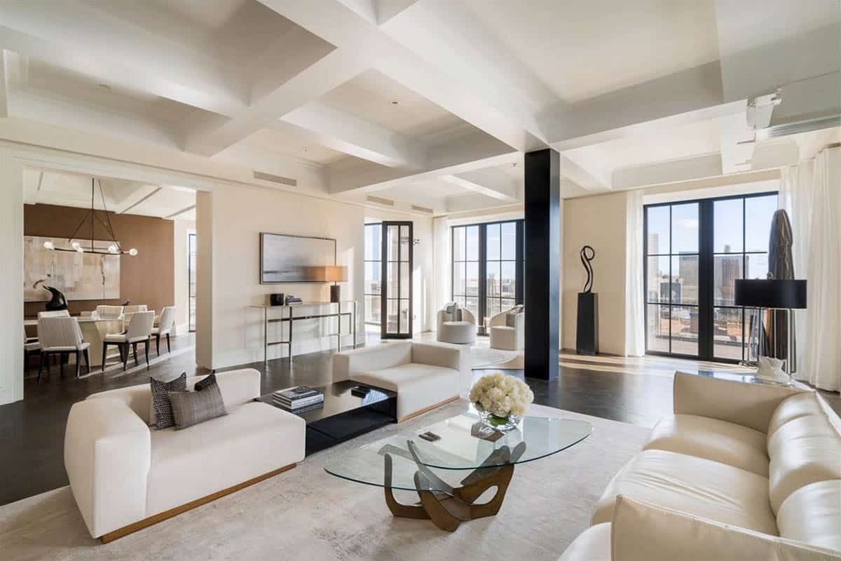 Modern living plan with cream furniture herringbone pattern floors and city views
