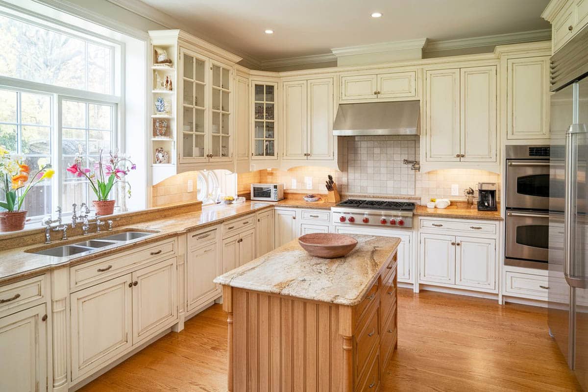 Traditional kitchen with beige granite and distressed cream cabinets