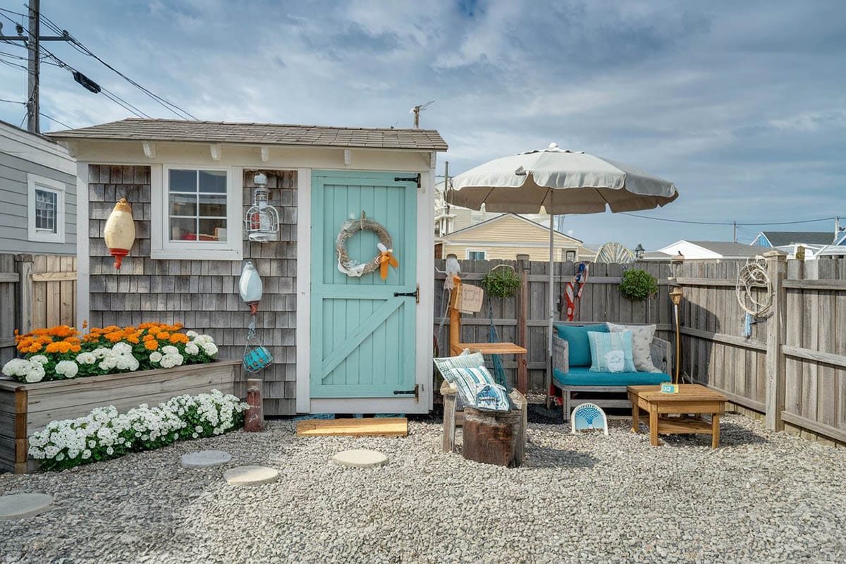 Backyard with gravel patio and wood shingle shed