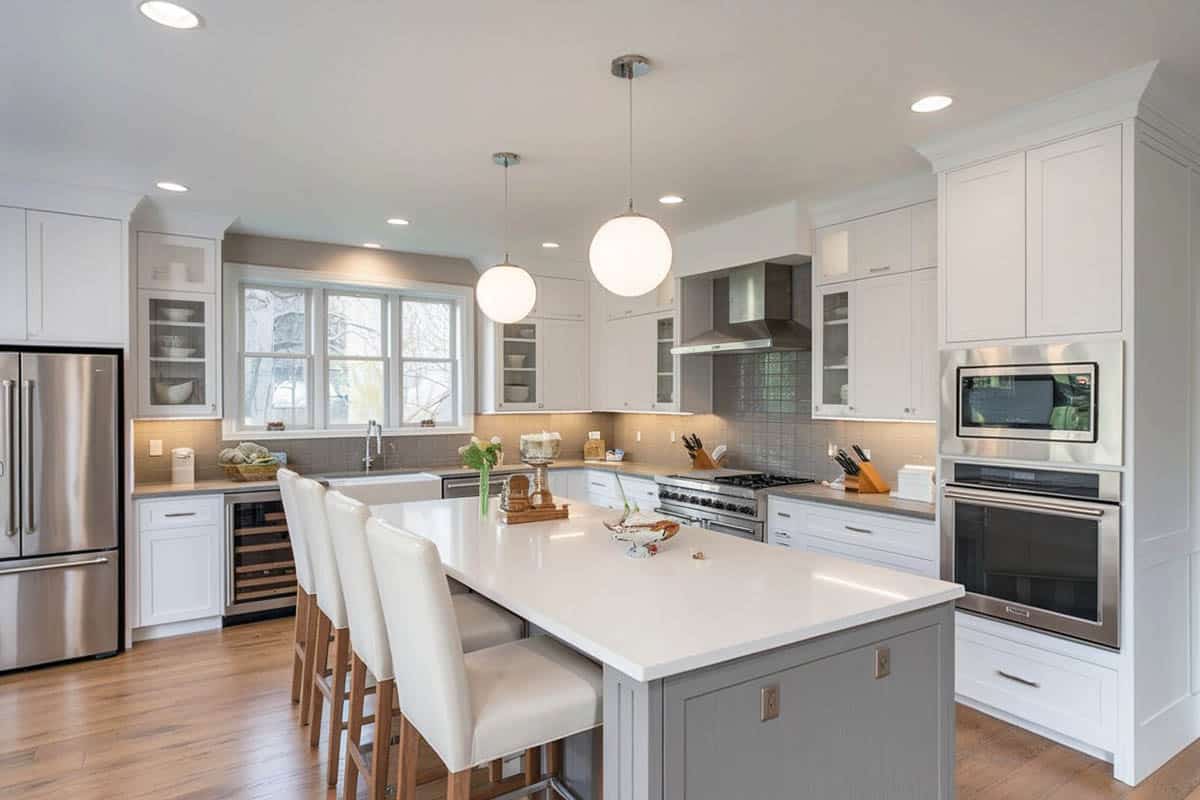 Beautiful kitchen with medium gray breakfast bar island and white shaker cabinets
