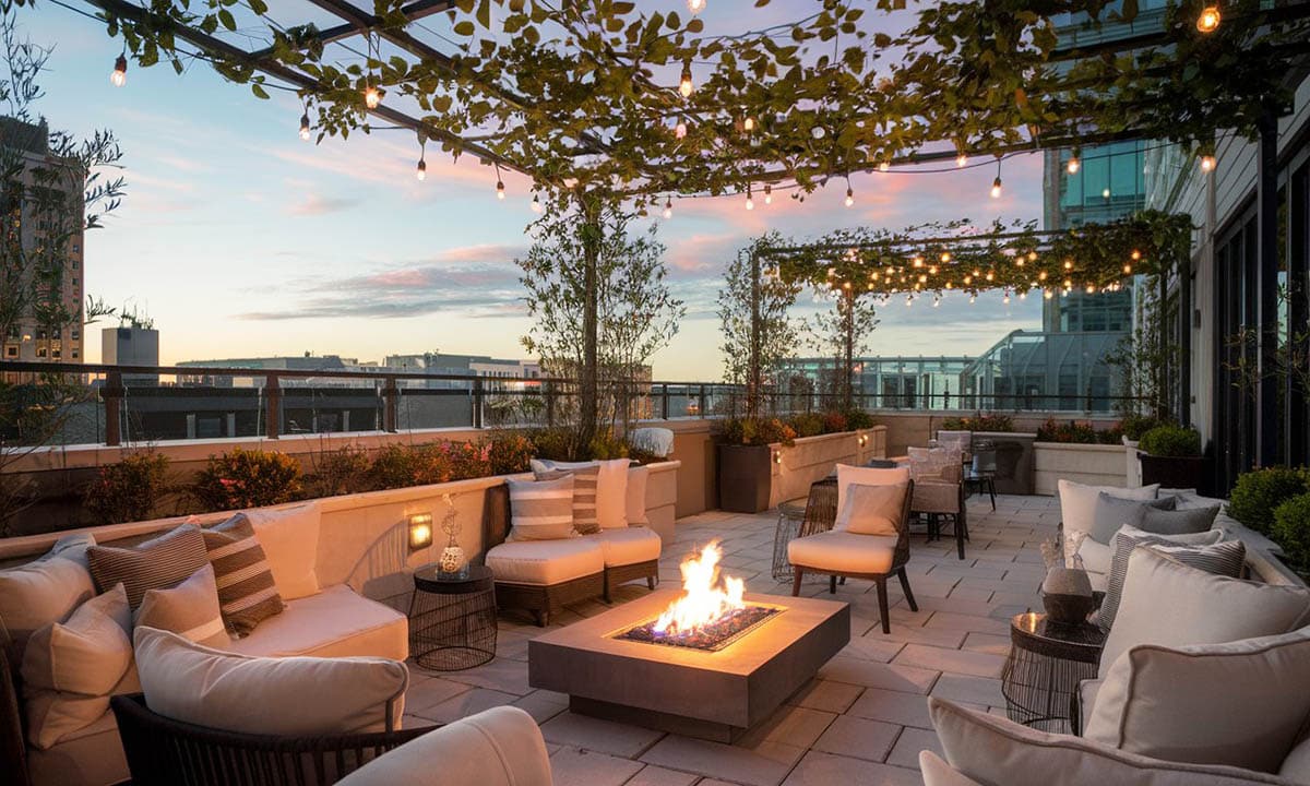 Beautiful rooftop patio area with landscaped plants and furniture