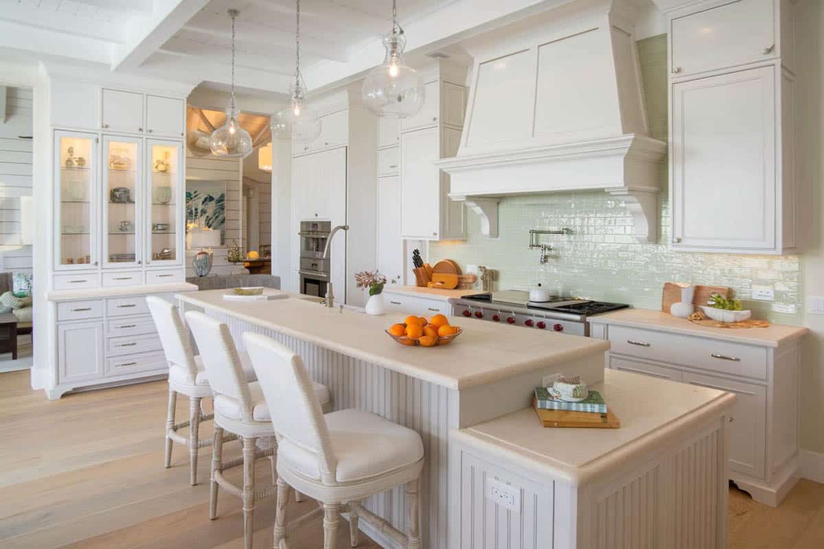 L-shaped kitchen with beadboard island in gray tone with beautiful aqua backsplash