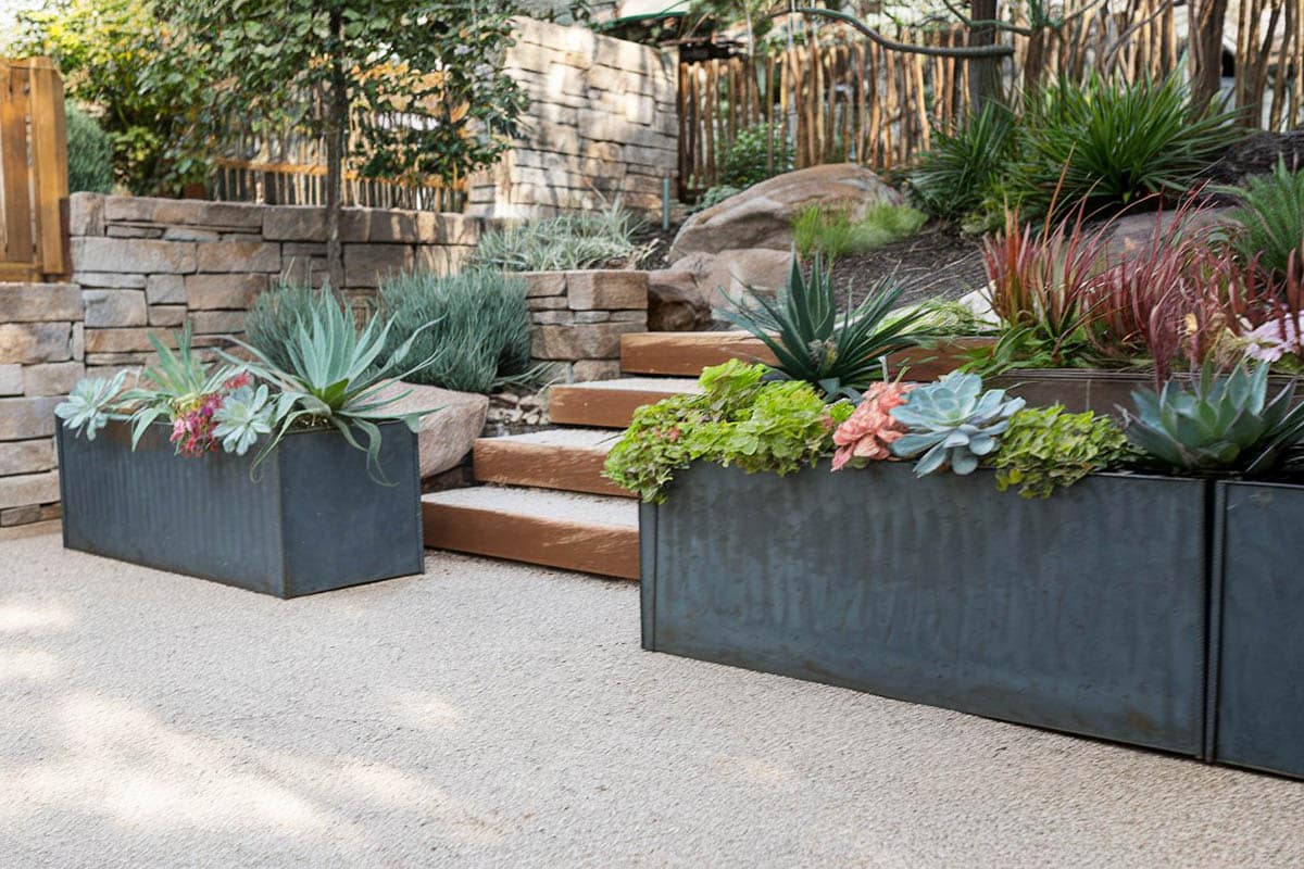 Steel bloom planter on concrete flooring