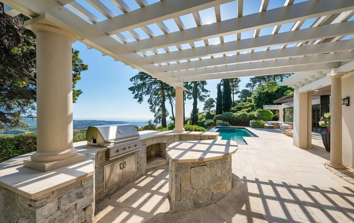 Mediterranean style patio with outdoor kitchen and covered pergola