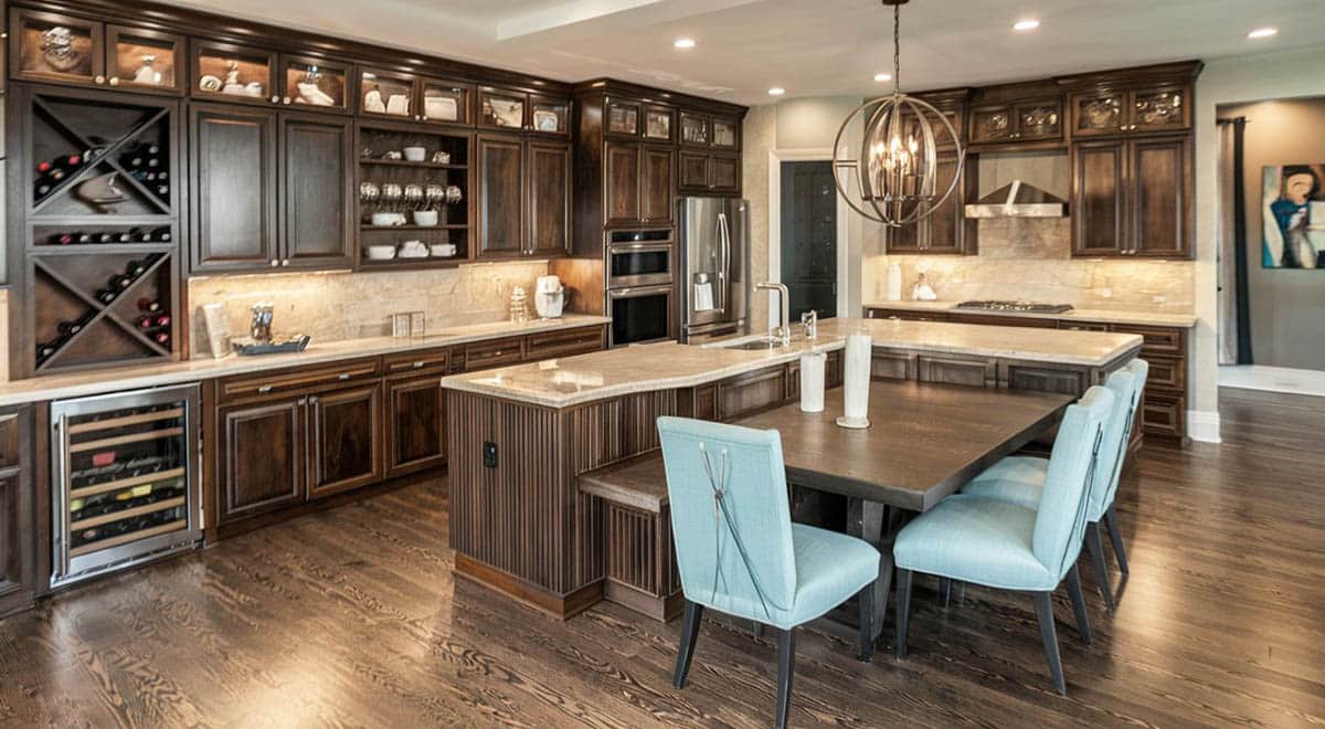 Dark tone kitchen with island, dining table and bench combo
