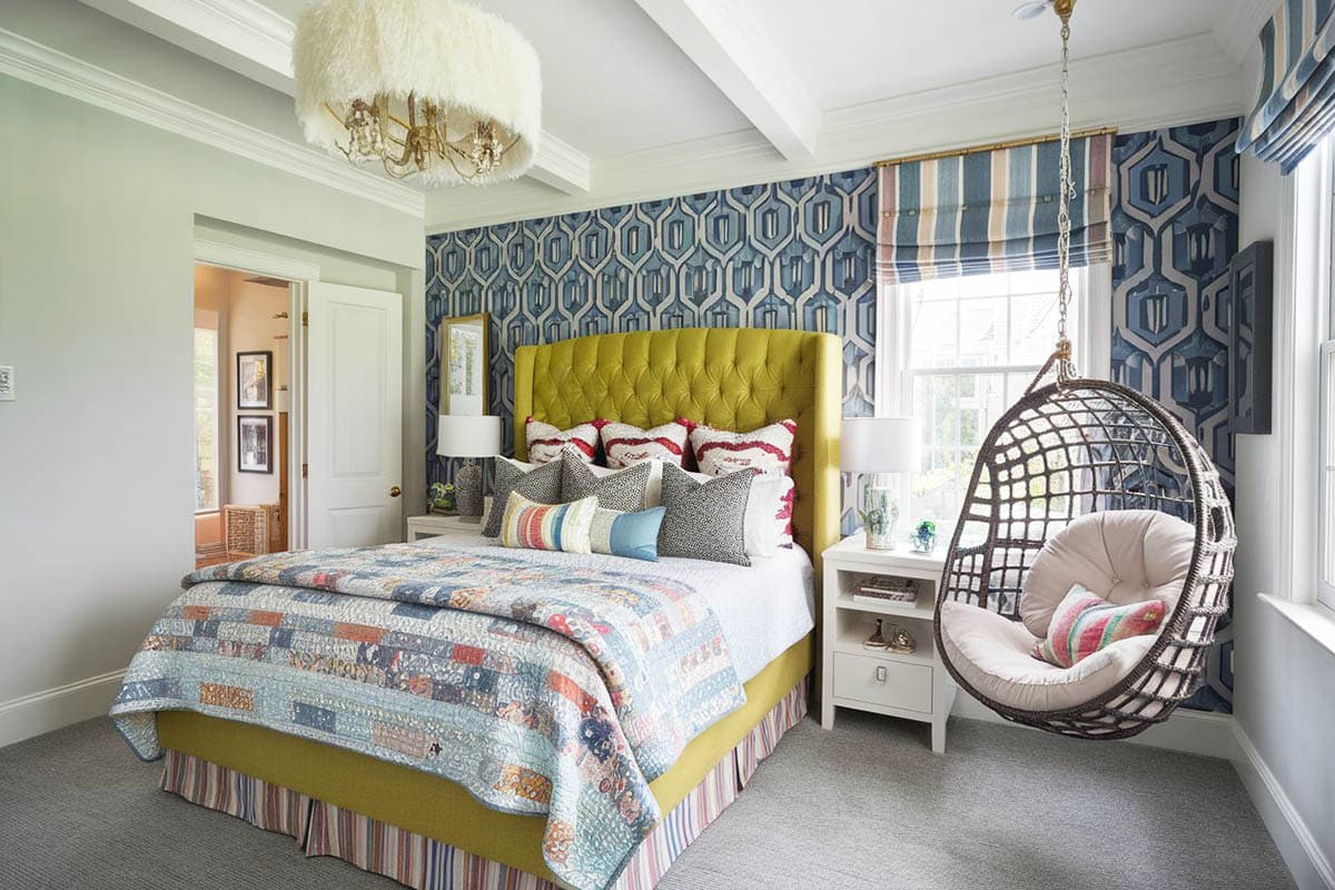 Luxury kids bedroom with rattan swinging chair bed with tufted headboard and glam feather chandelier