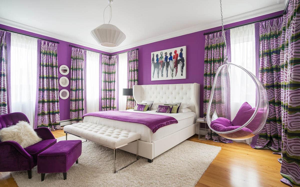 Teens bedroom with purple walls, shag carpet and see through swinging bubble chair with cushions