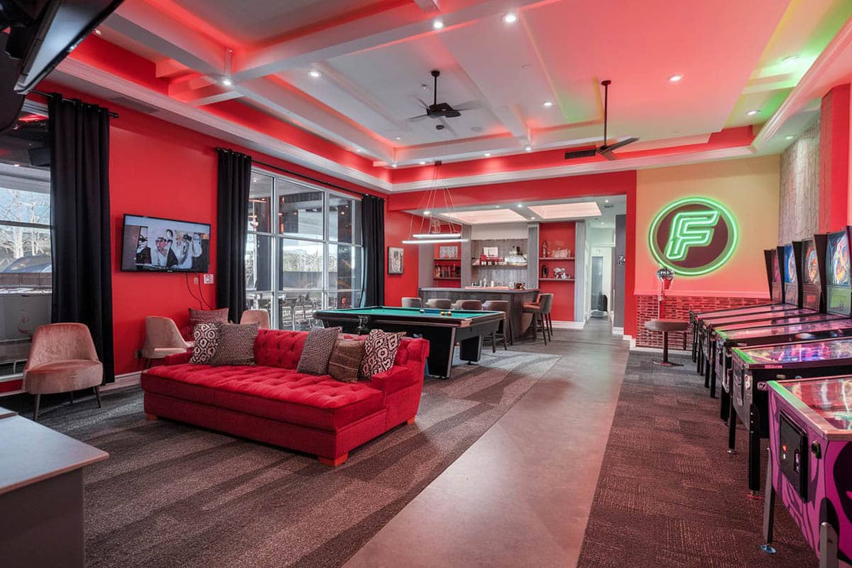 Game lounge with red furniture, comfy sofa and pinball machines