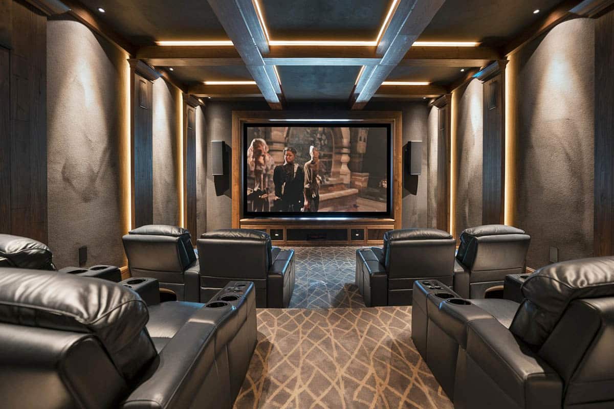 Room with rich leather seats, widescreen tv, and carpet flooring