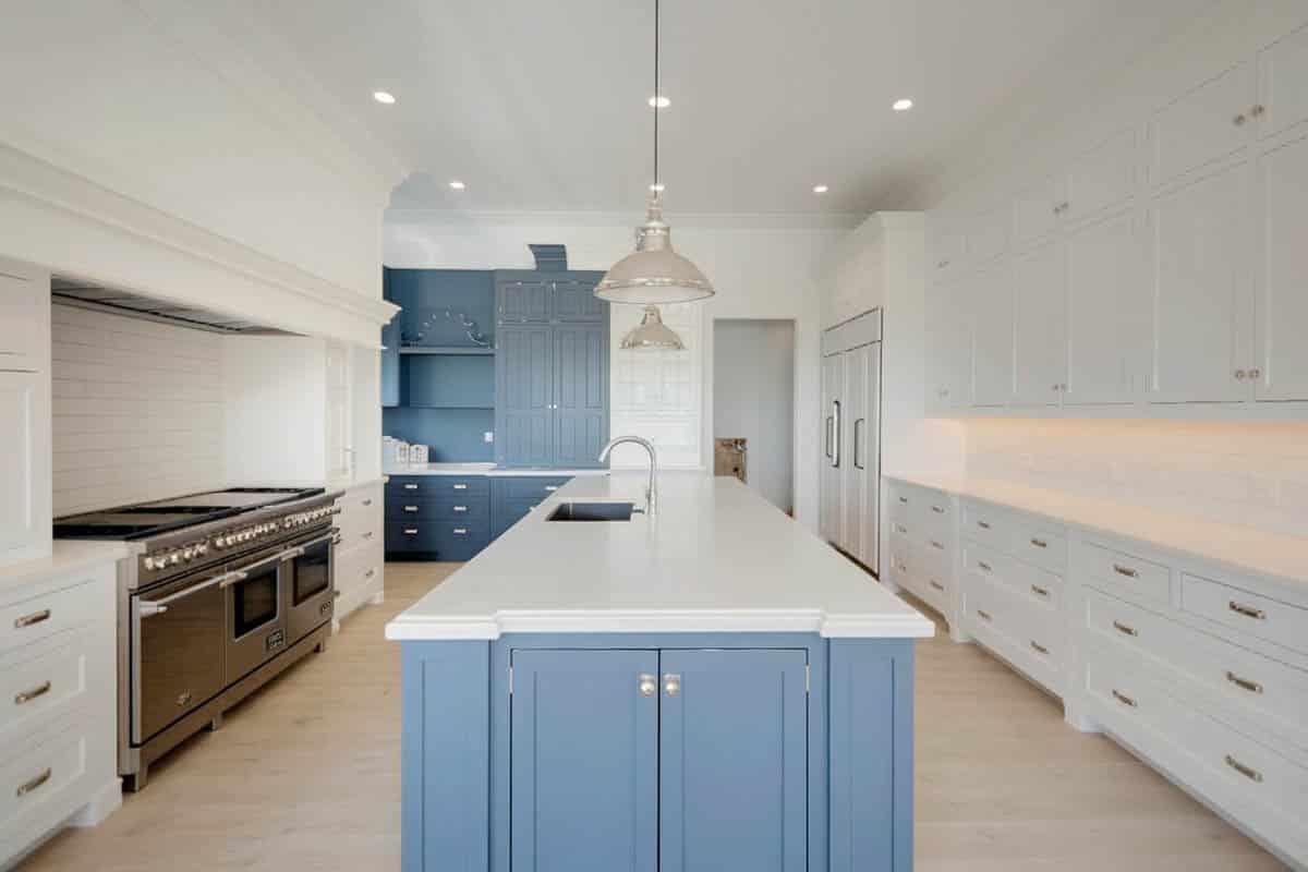 Cabinets with chrome handles with accent built in cabinet in blue gray color