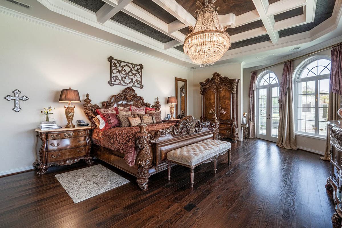 Bedroom with hickory hand scraped floors, chandelier and elegant furniture