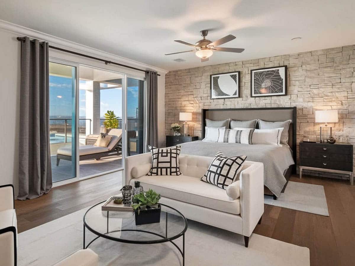Master bedroom with hickory hardwood floors and stone accent wall