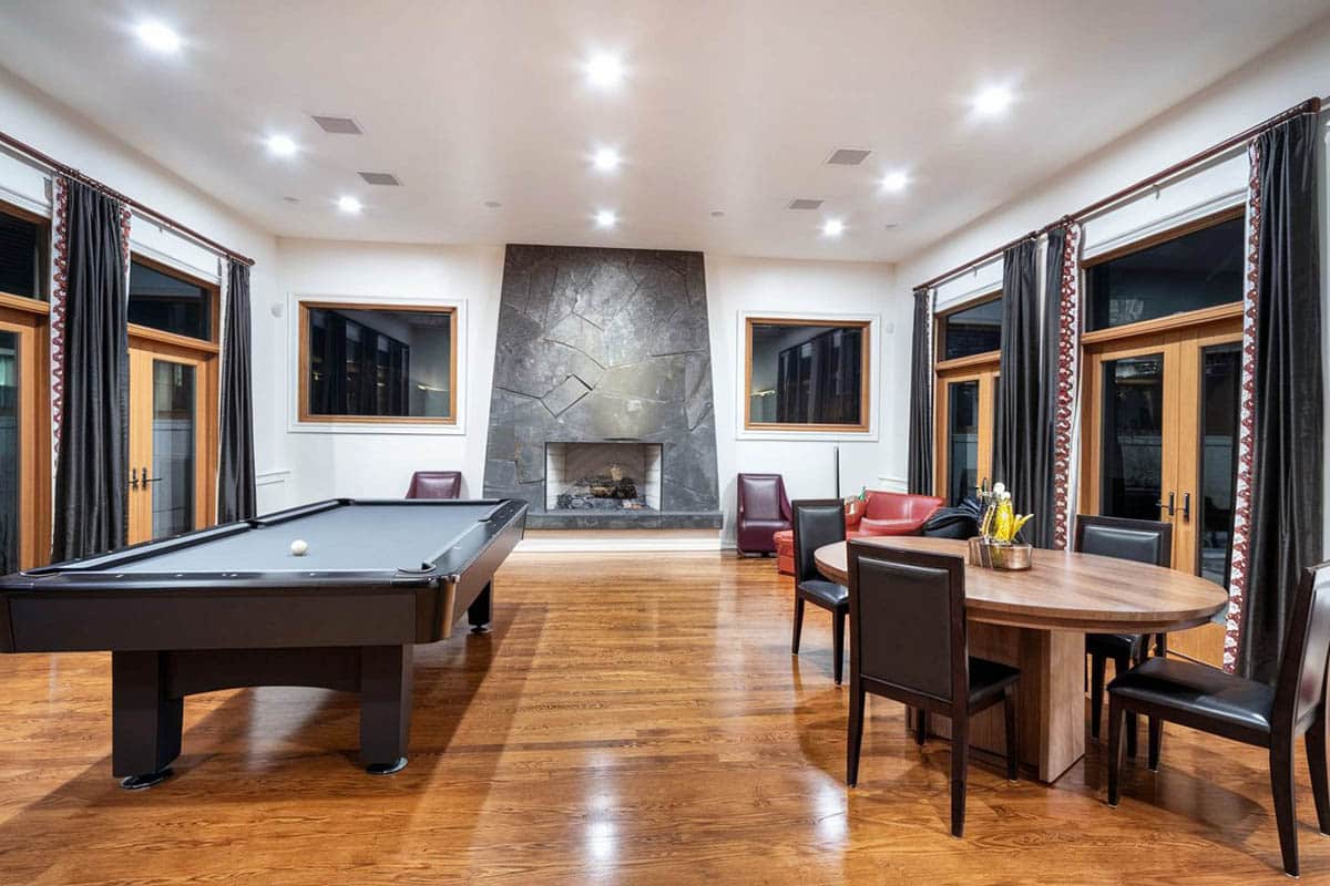 Modern hangout room with wooden flooring and fireplace