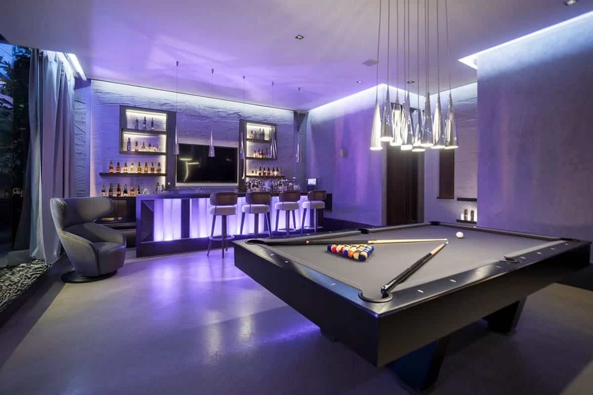 Modern neon fixtures and pendant lighting over glowing bar