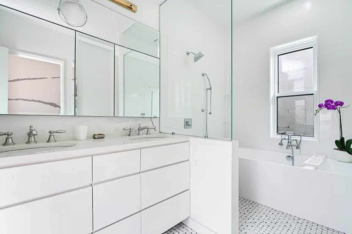 White bathroom with tub beside shower