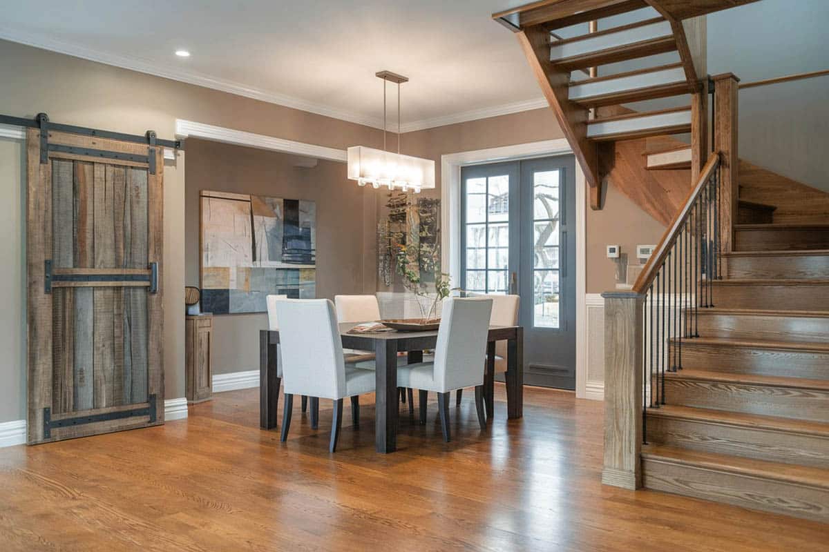 Contemporary dining room with drawbridge sliding barn door