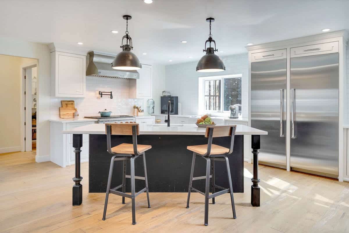 Island with dark painted base, light counter and white main cabinets