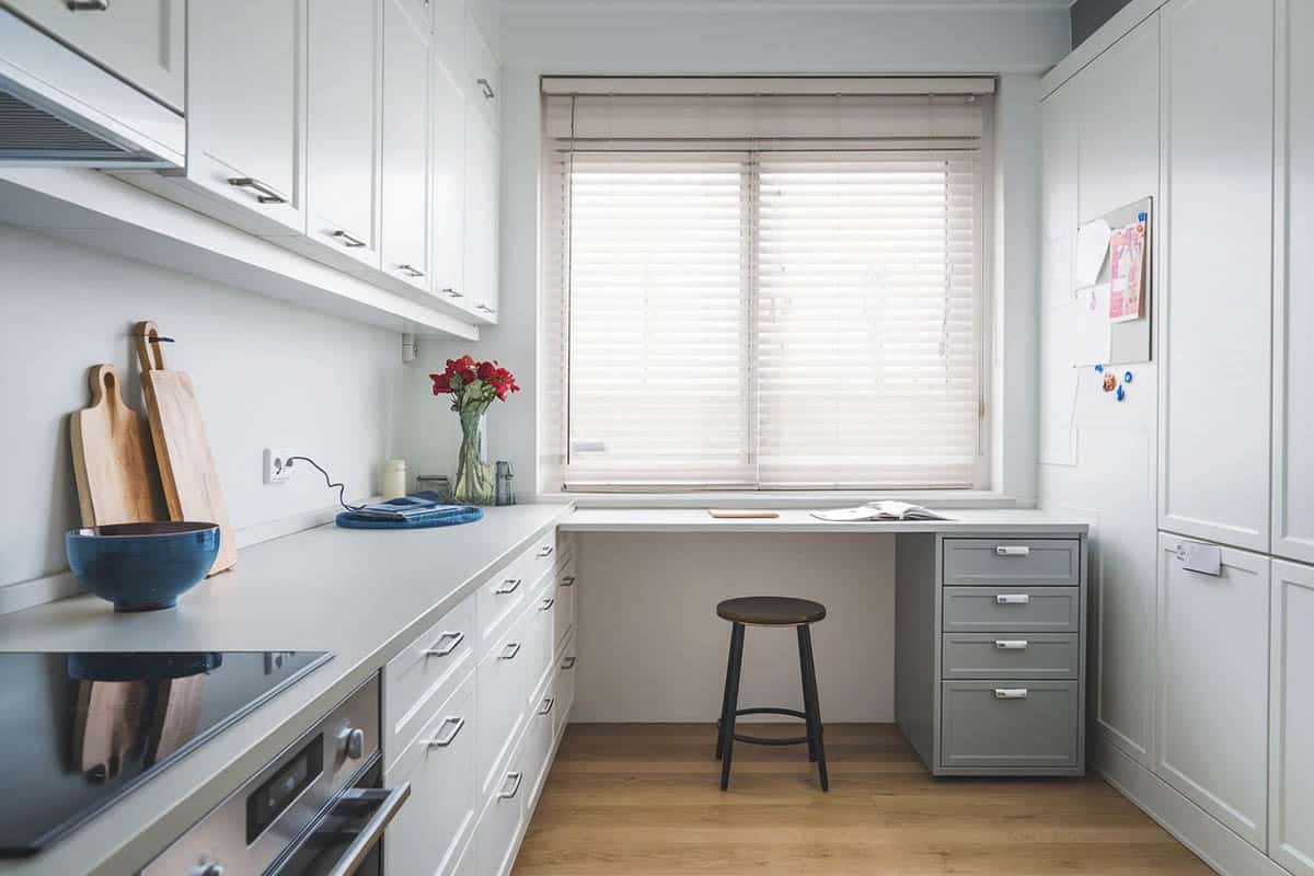 Kitchen with desk with quartz countertop next to window