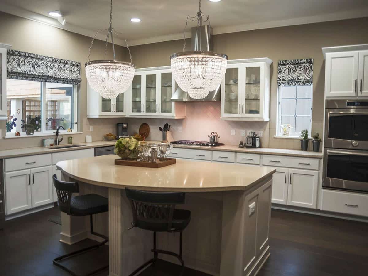 Kitchen with breakfast bar island and white cabinets with silver pulls