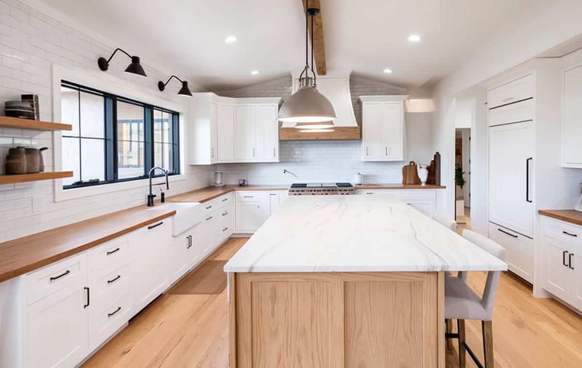 Kitchen with articulating sconce lighting above sink