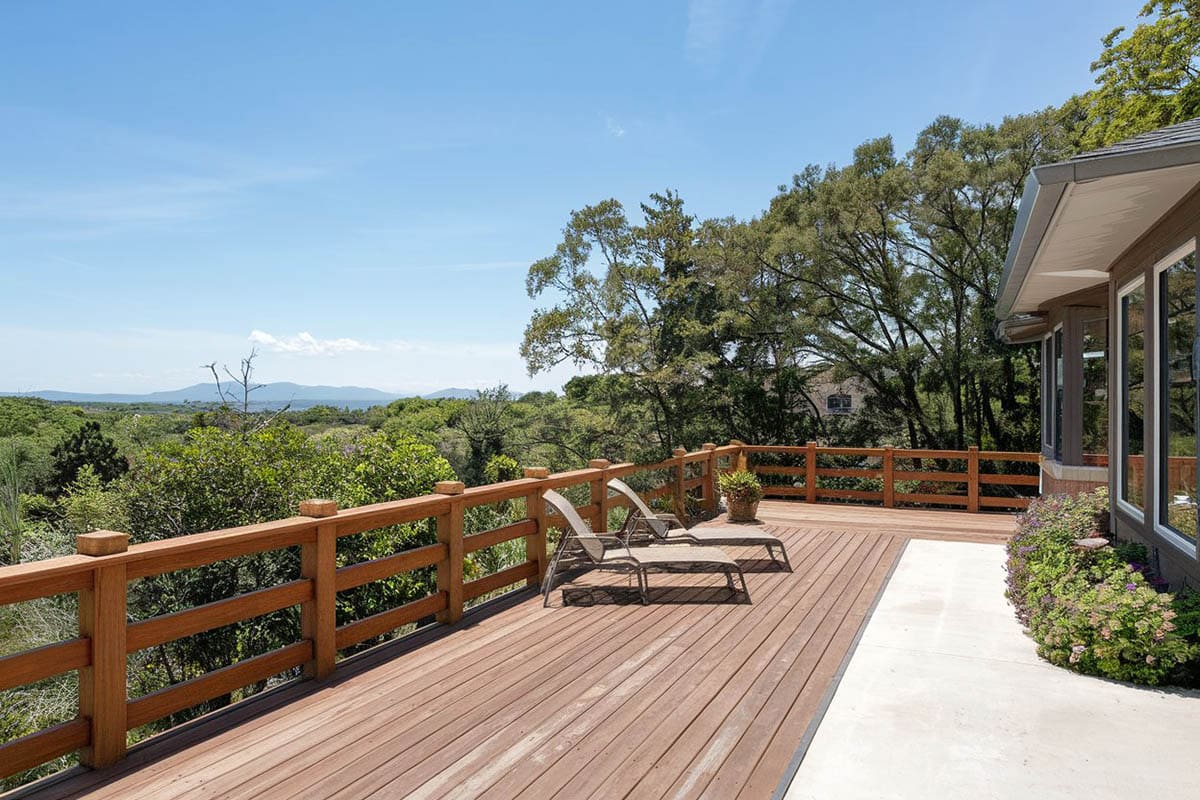 Beautiful deck with lounge chairs next to flower planter
