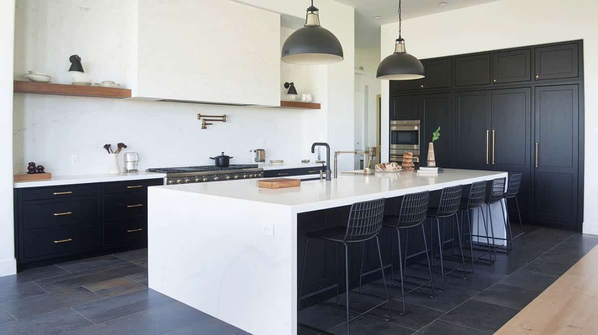 black and white kitchen with bright quartz island countertops