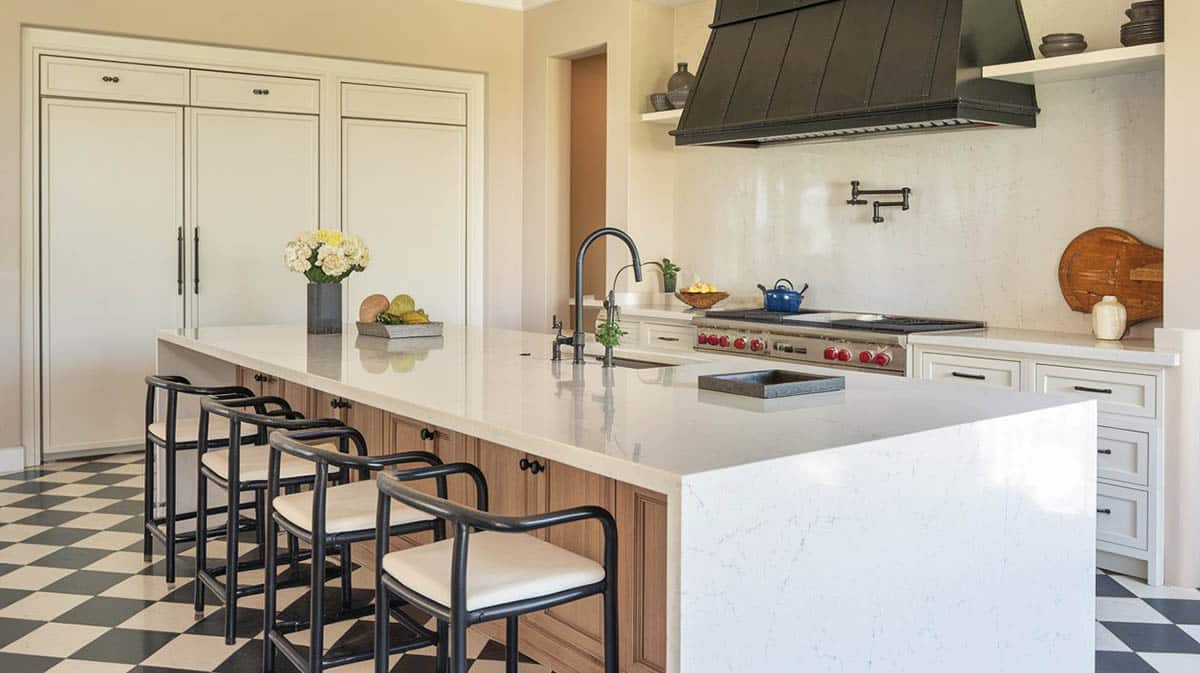Contemporary kitchen with brown island white shaker cabinets waterfall quartz countertops