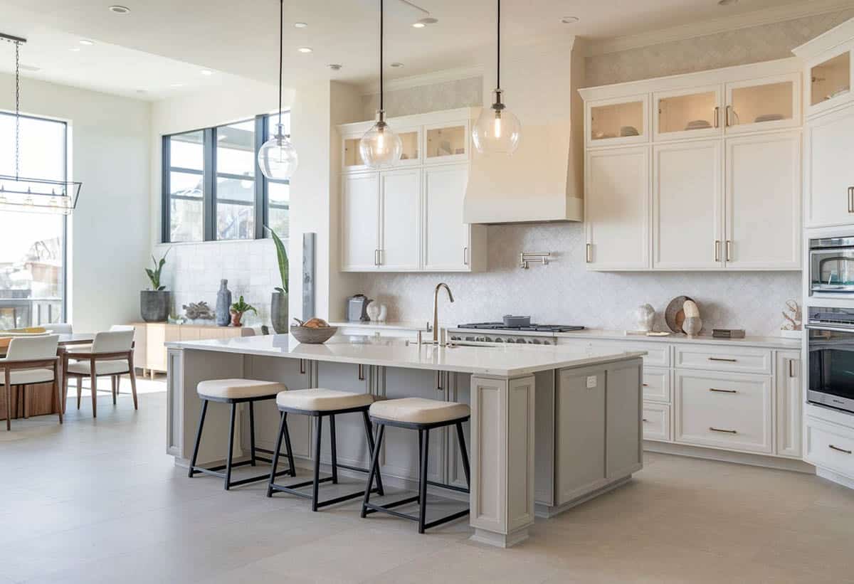Kitchen with white and glass door cabinets, gray island and white quartz countertops
