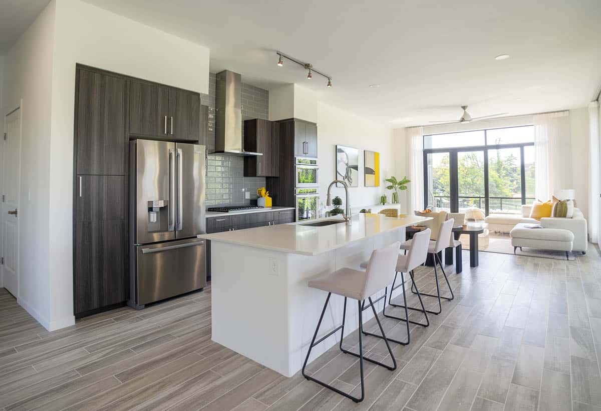Modern kitchen and living space with gray wood look porcelain tile floor