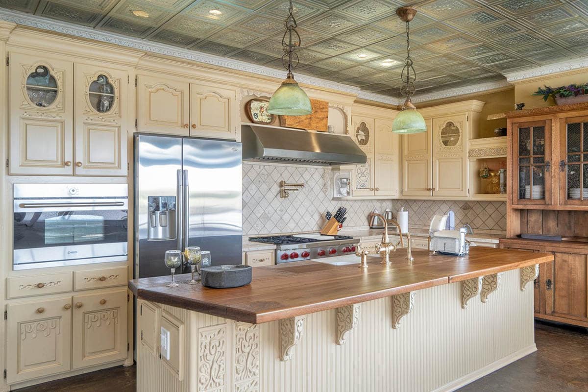 kitchen with stained glass pendant lights and beadboard island