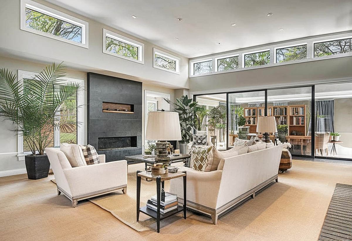Contemporary living room design with clerestory windows black accent wall fireplace
