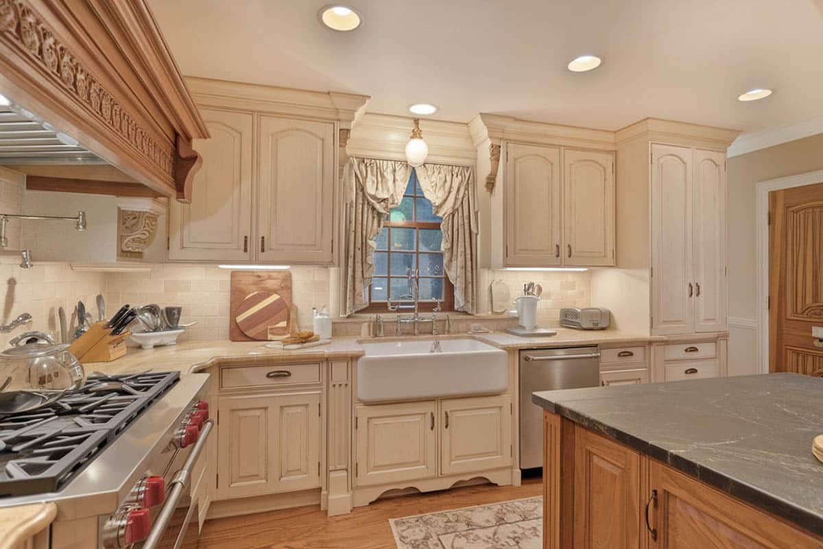 Kitchen with black soapstone counter and farmhouse style wash basin