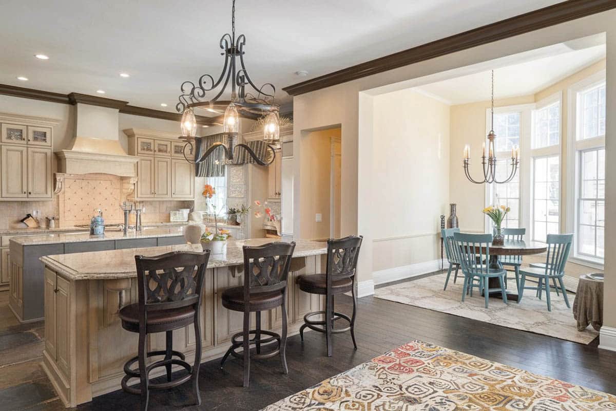 Cream color kitchen with two islands and dining window nook