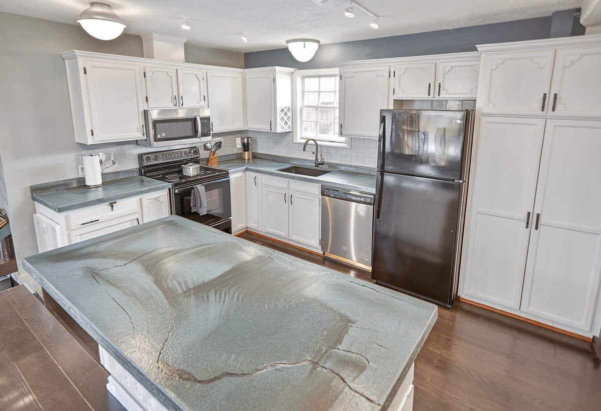 Kitchen with beige resin island and countertops