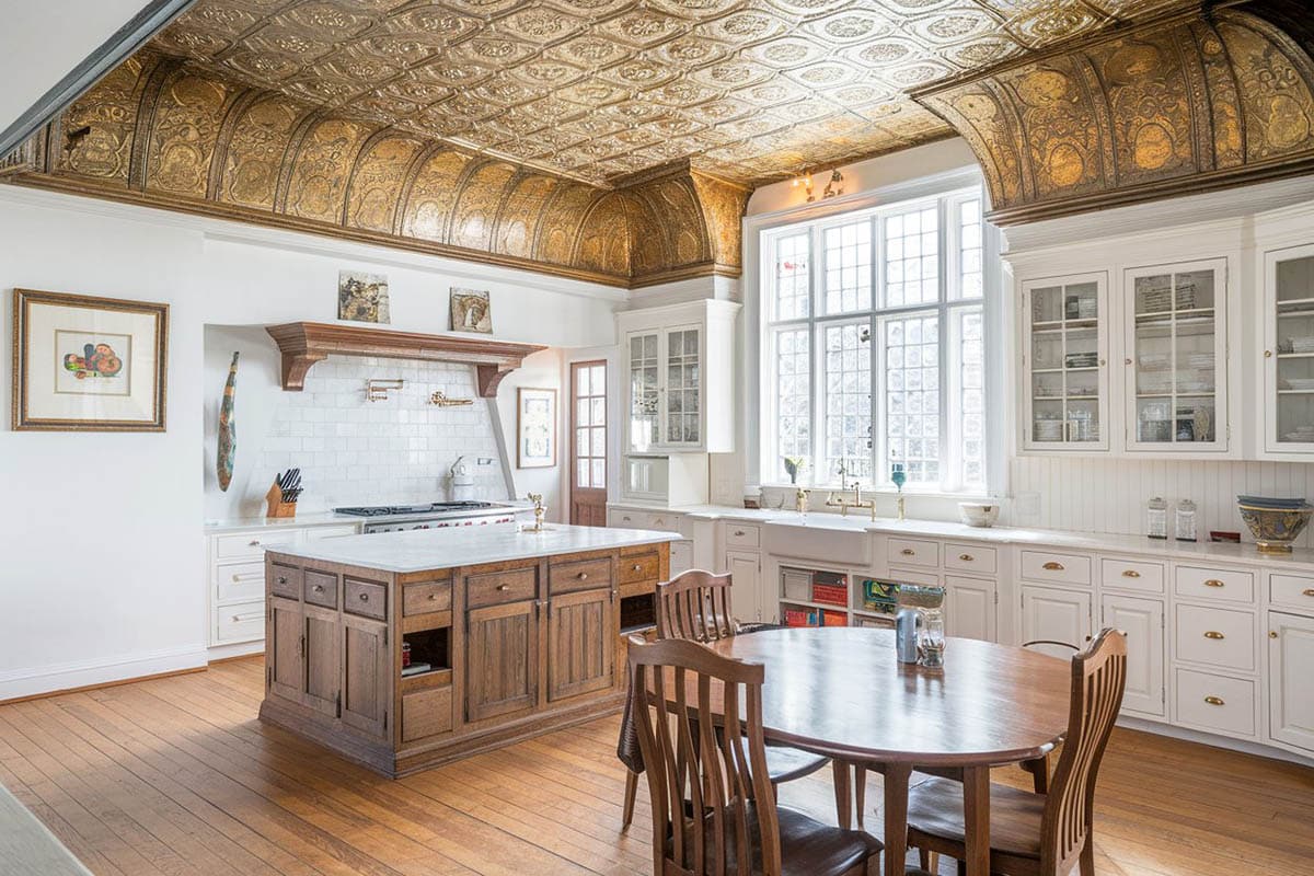 Kitchen with decorative metal ceiling and two tone cabinets