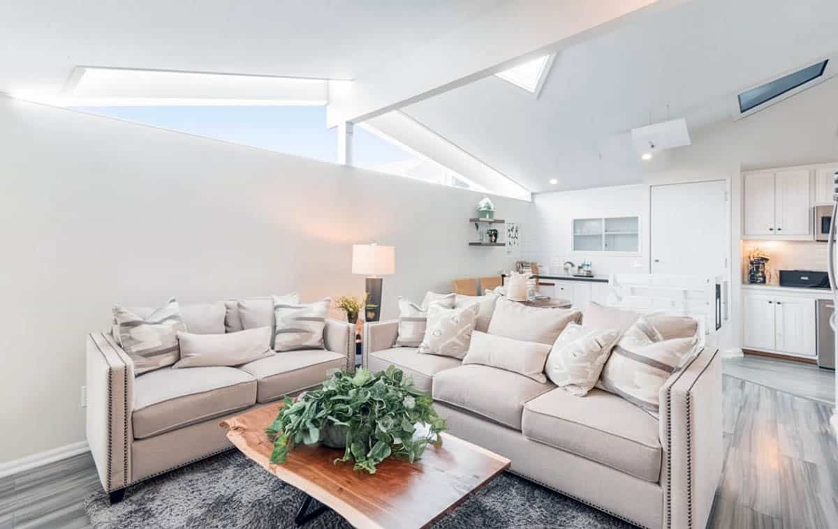 Open concept living room with clerestory windows cathedral ceiling wood flooring