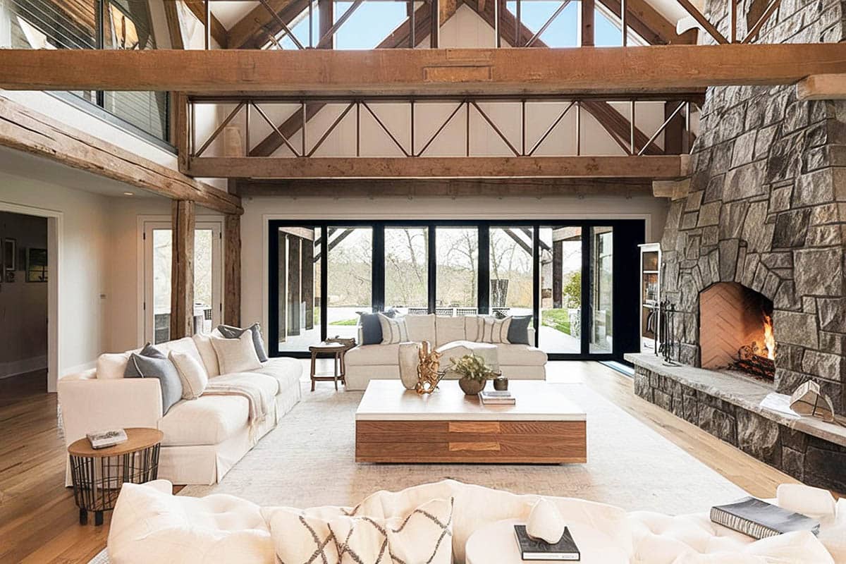 Rustic great room with cathedral style ceiling and stone fireplace