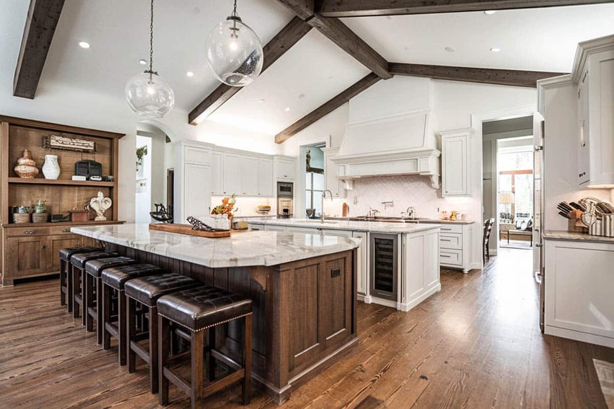 Transitional kitchen with cathedral design ceiling and large double islands