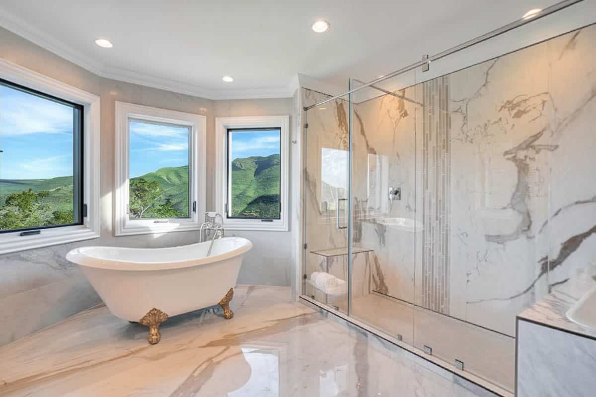 Bathroom with wraparound windows and tub with clawfoot design