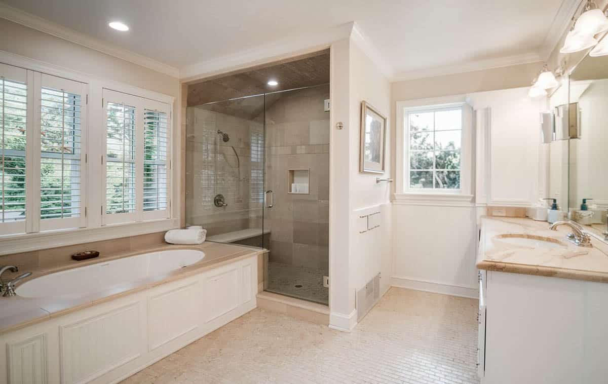 Bathroom with travertine tiles and window with shutters