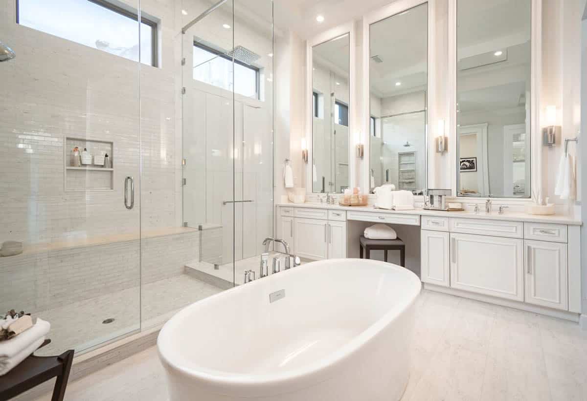 Bathroom with high ceilings, a corner bench and central tub