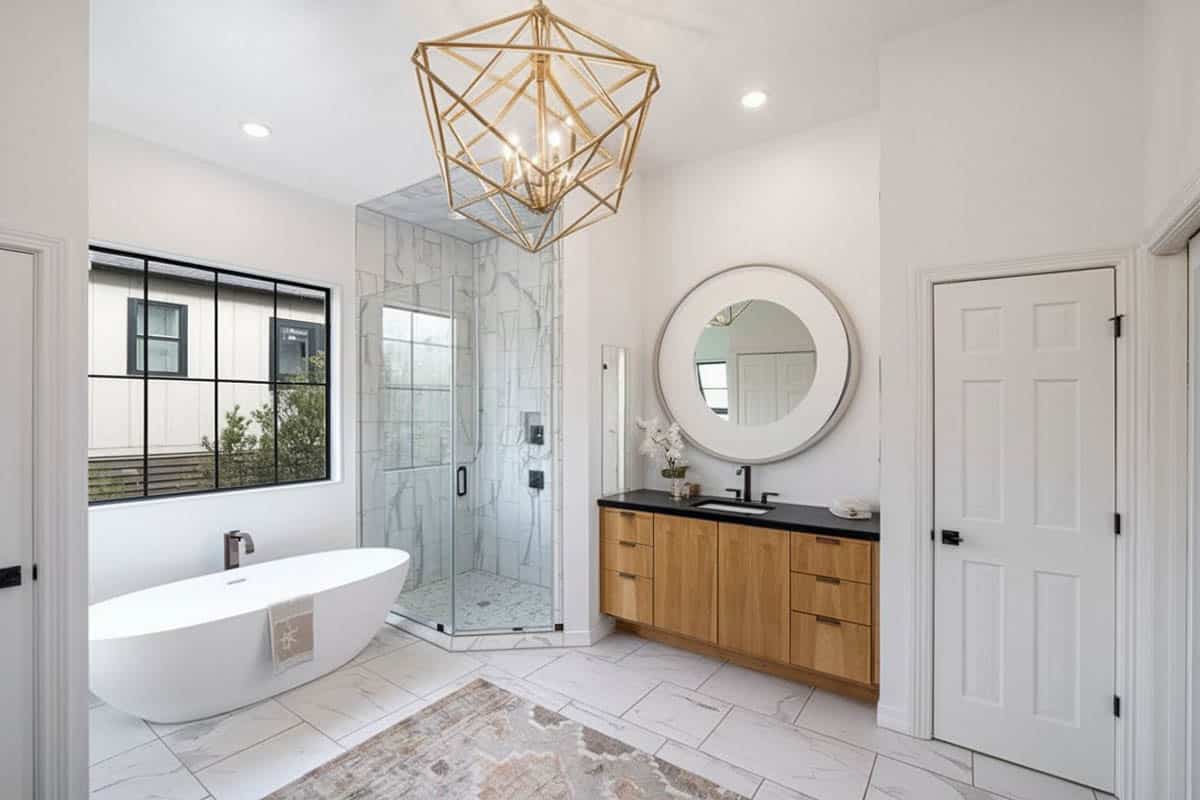 Bathroom with inset tiled shower and gold chandelier