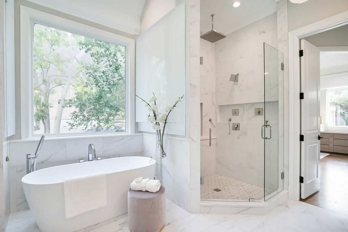 Bathroom with mosaic shower tiles and white freestanding tub