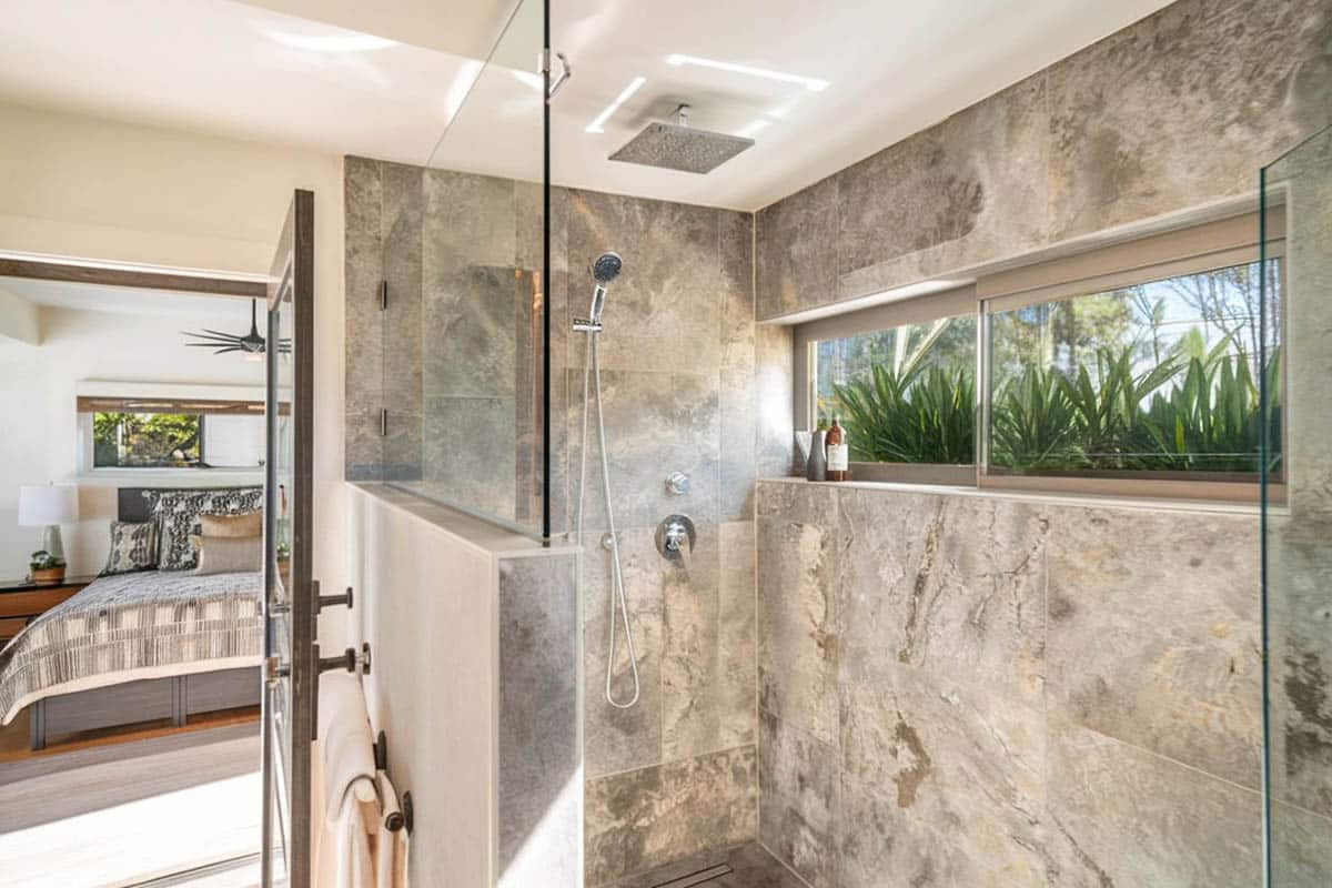 Shower area with stone material and white ceiling