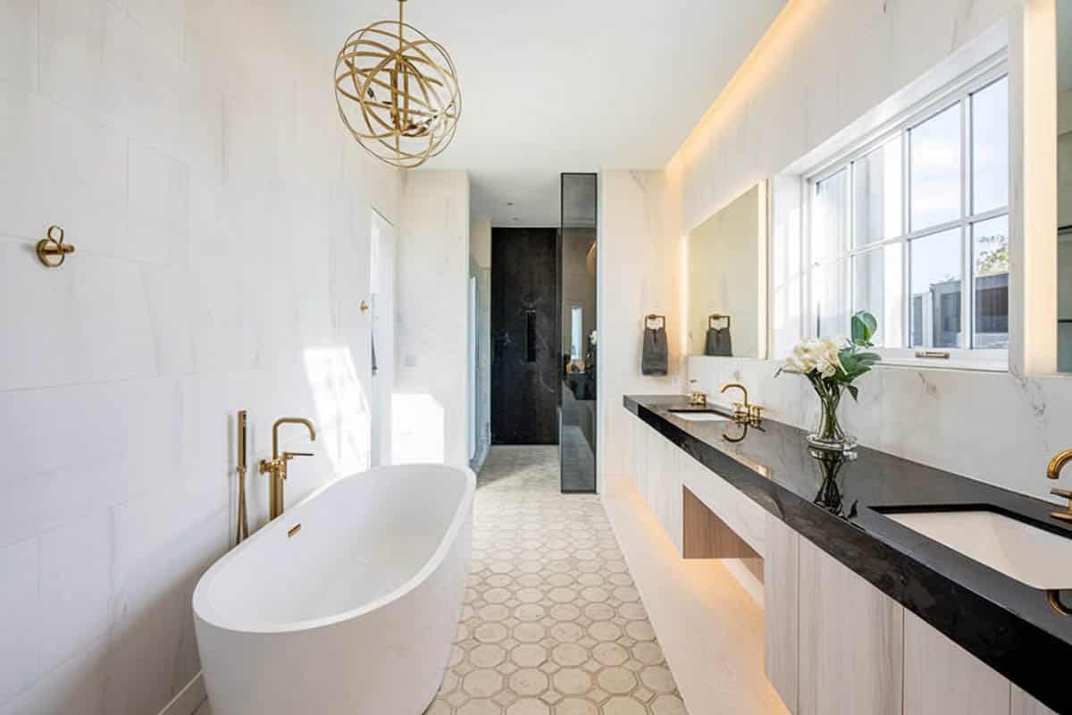 Bathroom with gold accent, windows and backlights
