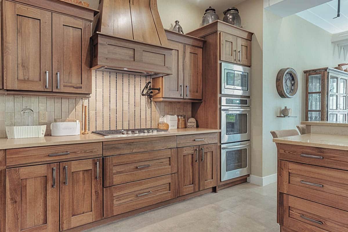 Craftsman type cooking area with flat paneled cabinet doors